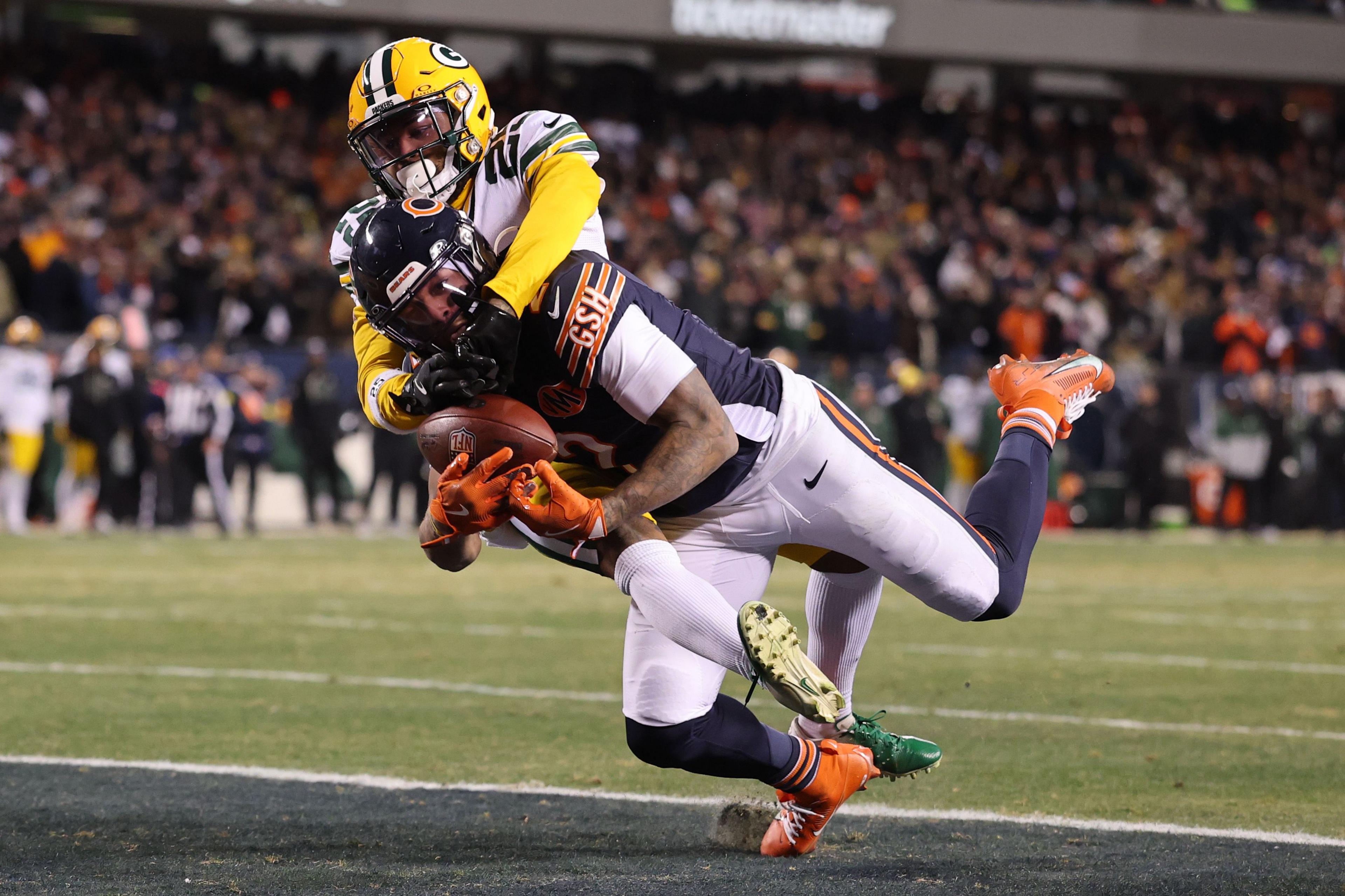 The Chicago Bears' DJ Moore catches a touchdown pass despite close attention from the Green Bay Packers' Keisean Nixon during overtime at Soldier Field in Chicago