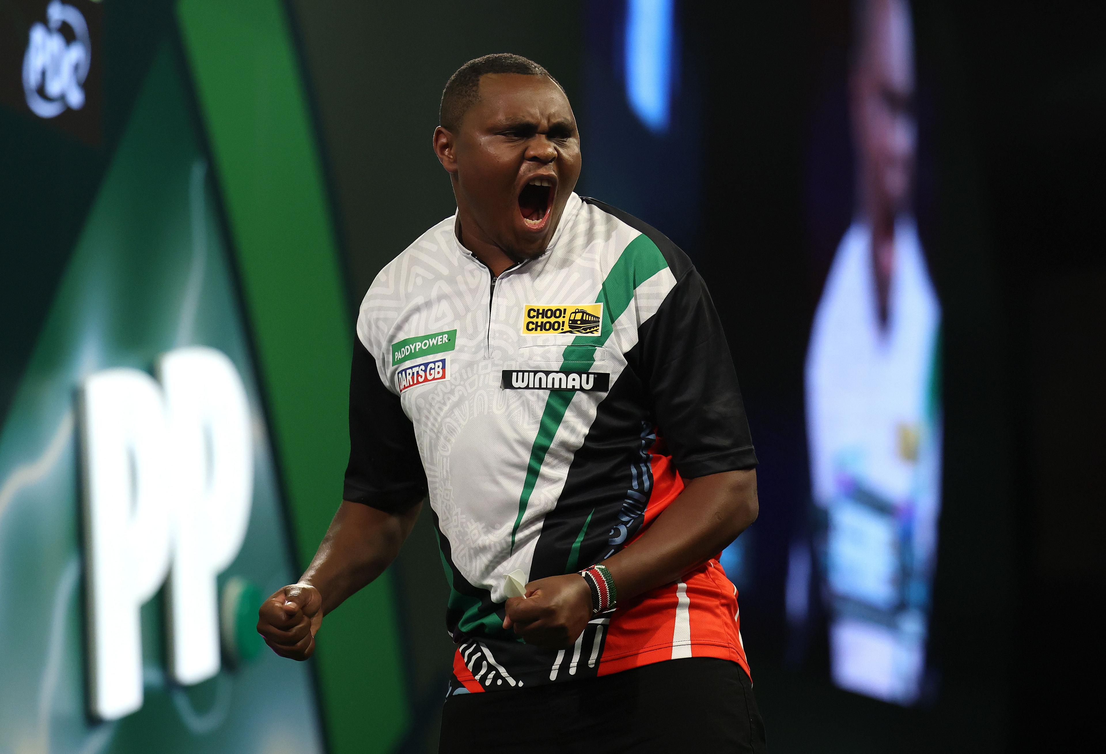 Kenya's David Munyua celebrates after winning his match on day eight of the World Darts Championship at Alexandra Palace